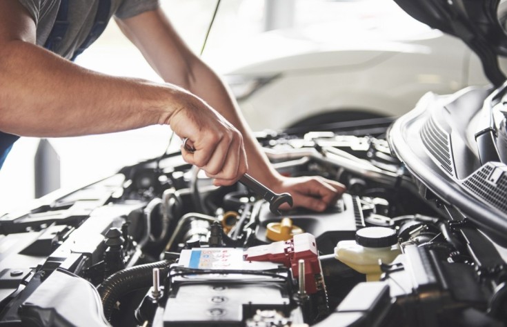 muscular-car-service-worker-repairing-vehicle-1-1